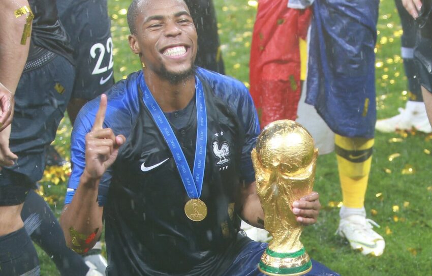 Chelsea player holding FIFA World Cup trophy