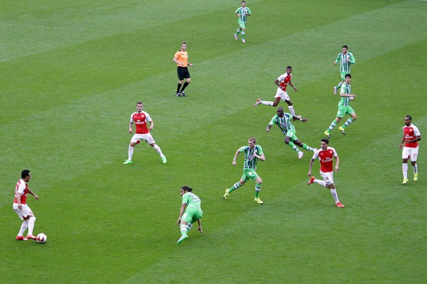 Arsenal and Borussia Dortmund players on the pitch at Emirates Stadium